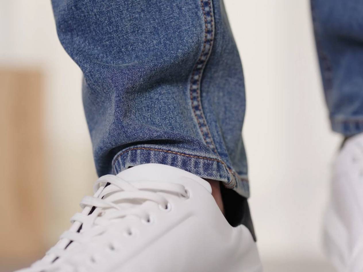 Jeans und weiße Sneaker.