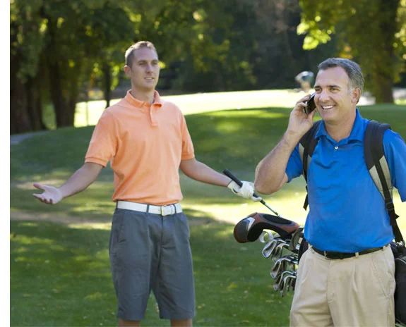 Golfer auf dem Platz, Golfschläger und Handy.
