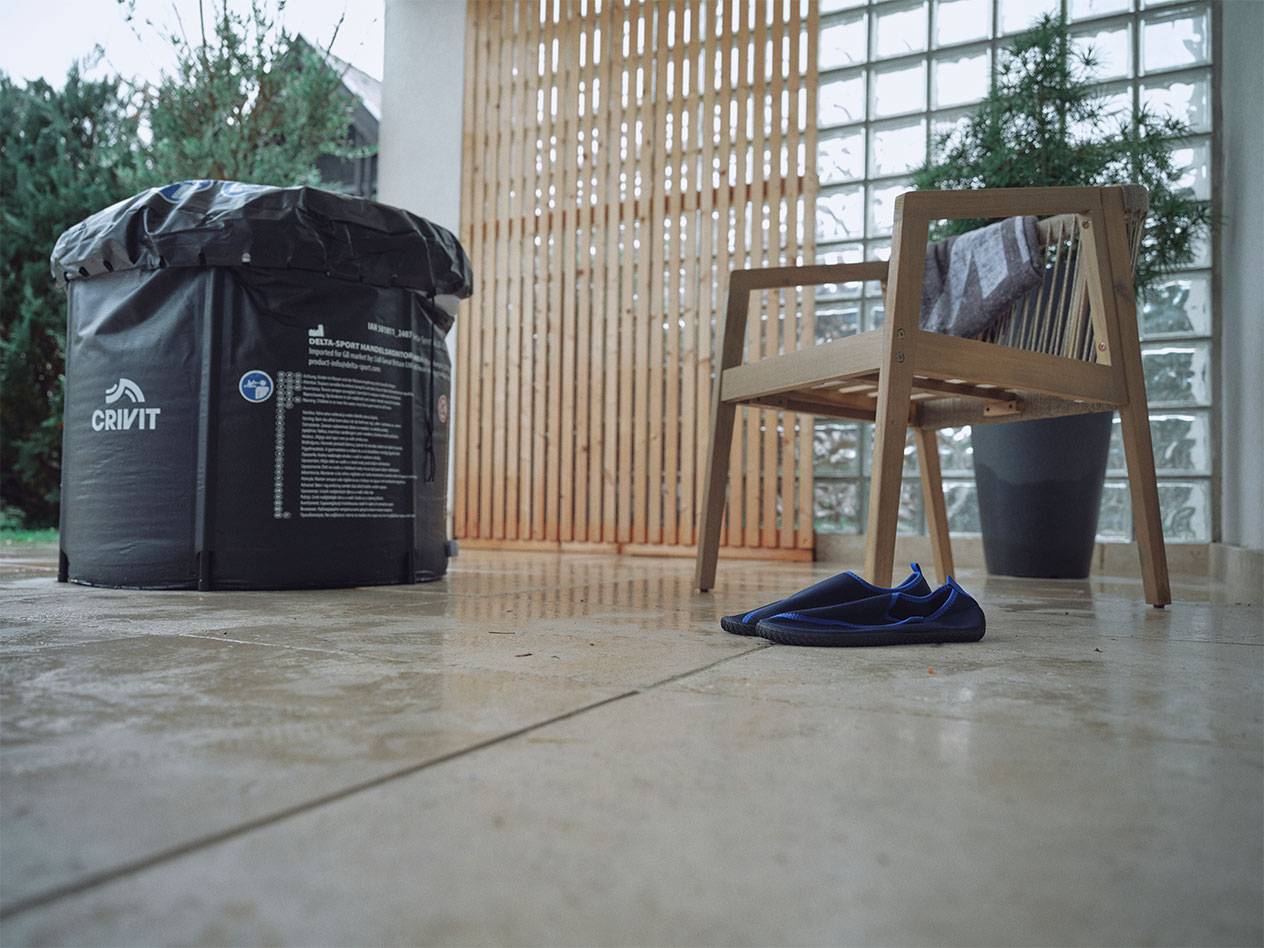 Crivit aufblasbarer Pool und Wasserschuhe auf einer Terrasse.